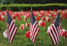 3 American Flags in a field of flowers
