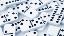 A pile of white tiles with black dots